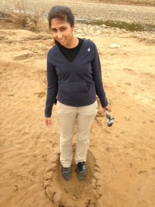 Noreen standing in an elephant footprint!