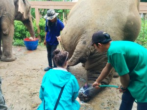 Katelyn scrubbing a landmine injury with chlorhexidine solution to clean the wound